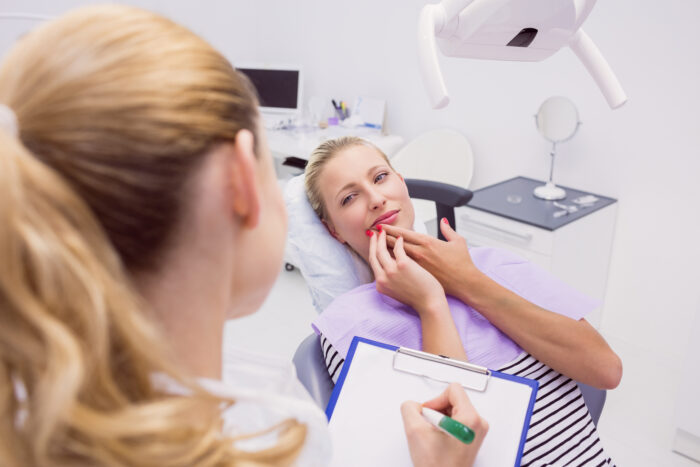 Portrait of female patient with toothache in clinic